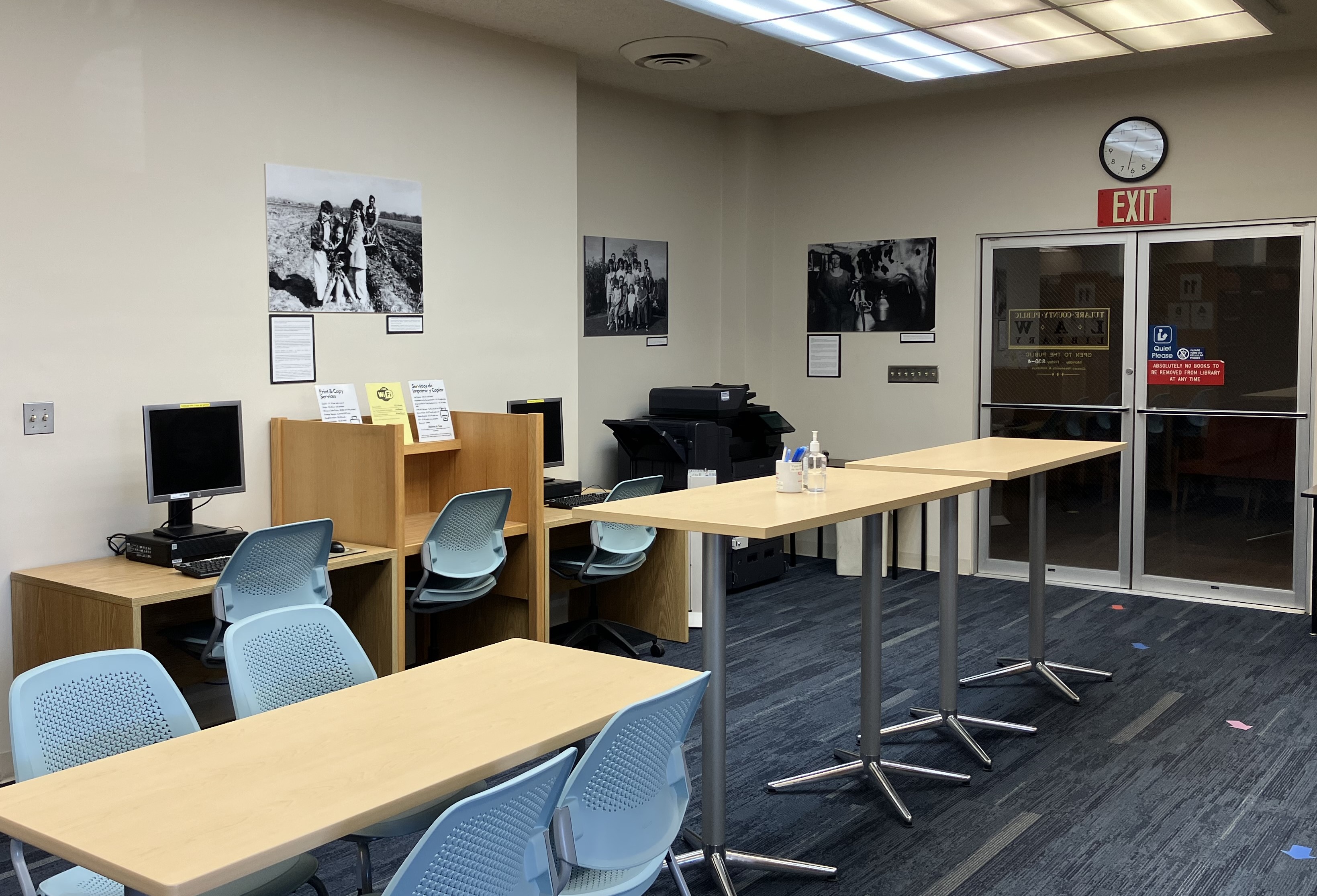 Picture of computers, copy machine, and tables and chairs.