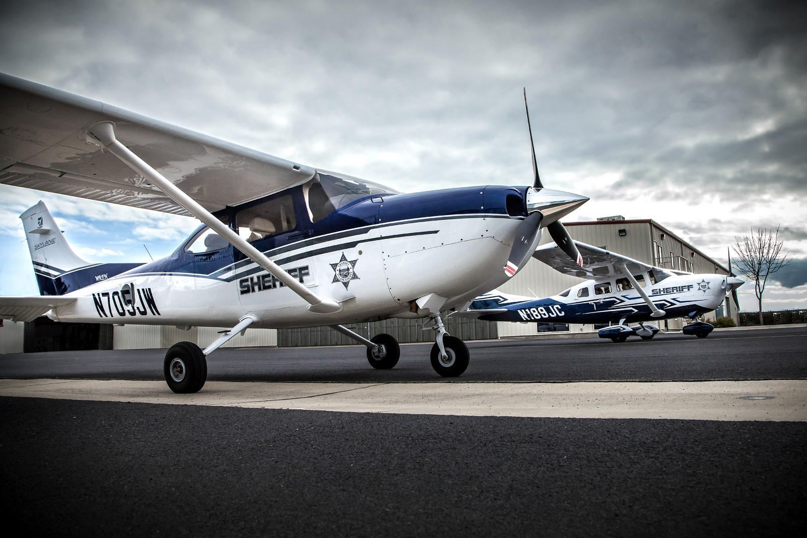 The Sheriff's two airplanes sit side by side at the Porterville Airport: Wren, at left, and Tribute, at right. Wren is a Cessna 182 which seats four, and Tribute is a Cessna 206 which seats six. 